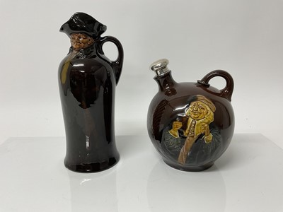 Lot 1080 - Royal Doulton Kingsware flagon with silver stopper, 19cm high, together with a Nightwatchmen flask, 26cm high (2)