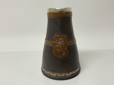 Lot 1084 - Doulton Silicon jug with copper studded decoration and Lion crest, with silver rim, impressed marks to base, 19cm high