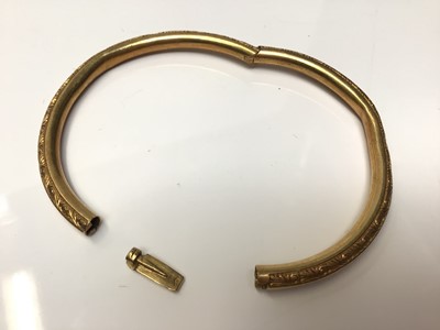 Lot 113 - Yellow metal bangle with engraved scroll decoration