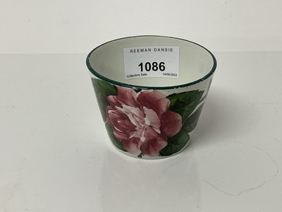 Lot 1086 - Wemmys pottery sugar bowl decorated with pink flowers, retailed by T.Goode & Co, 5.5cm high