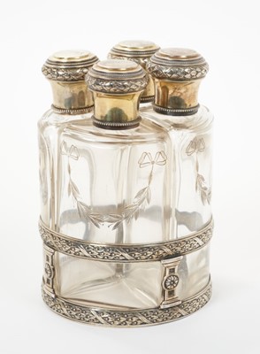Lot 358 - Late 19th century French silver mounted perfume set of four fitted bottles in a silver stand.