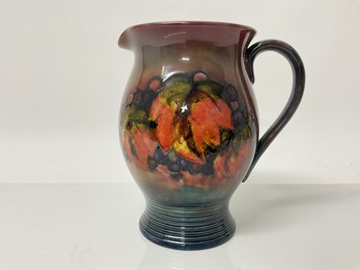 Lot 1105 - Moorcroft pottery Flambe jug decorated in the leaf and berry pattern, impressed marks and blue painted signature to base, 20.5cm high