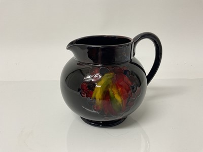 Lot 1106 - Moorcroft pottery Flambe jug decorated in the leaf and berry pattern, impressed marks, Potter To HM The Queen, painted signature, 12cm high