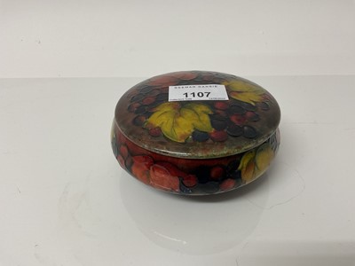 Lot 1107 - Moorcroft pottery Flambe pot and cover decorated in the leaf and berry pattern, impressed marks and blue painted signature to base, 11cm diameter