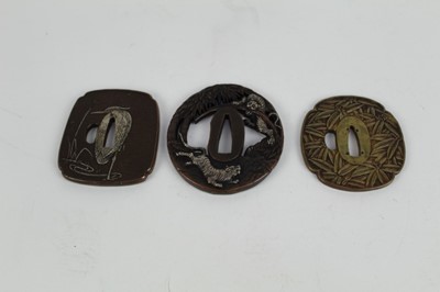 Lot 756 - Japanese bronze tsuba with pierced decoration depicting Tigers, together with two other bronze tsuba's (3)