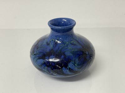 Lot 1110 - Moorcroft pottery squat vase decorated with foliage on powder blue ground, impressed marks and blue painted signature to base, 8.5cm high