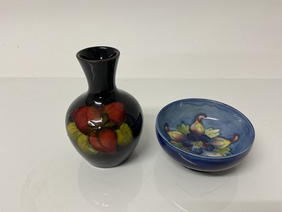 Lot 1113 - Small Moorcroft pottery vase with floral decoration, 9cm high, together with a small Moorcroft bowl, 7.5cm diameter (2)