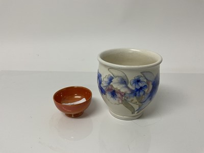 Lot 1114 - Moorcroft pottery vase decorated with blue flowers on white ground, impressed marks and blue painted signature to base, 8.5cm high, together with a miniature orange glazed bowl, 5.5cm diameter (2)