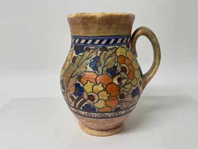 Lot 1117 - Charlotte Rhead Crown Ducal jug with orange and blue floral decoration, signed, 25.5cm high