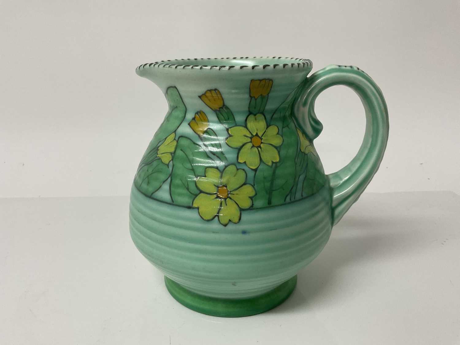 Lot 1118 - Charlotte Rhead Crown Ducal jug with floral decoration on green ground, signed, 15.5cm high