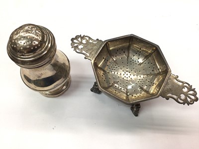 Lot 988 - A silver octagonal tea strainer and stand and a silver bun top castor