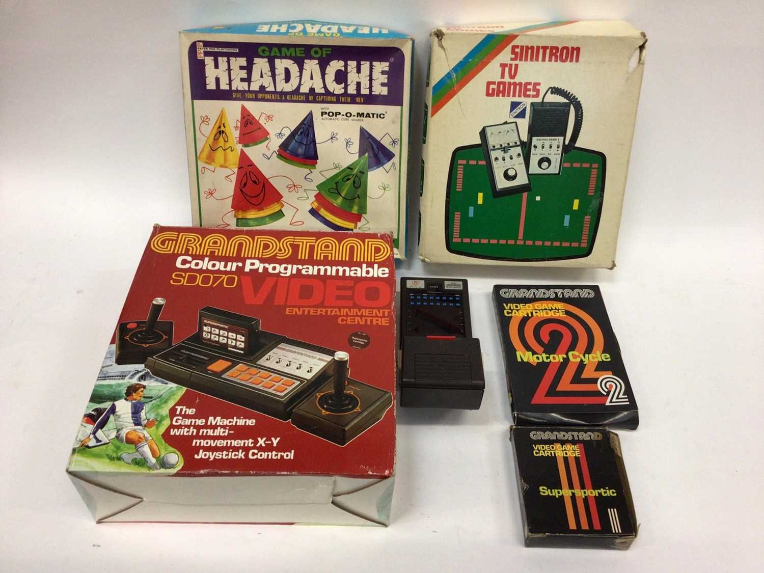 Lot 1878 - Selection of Children's computer and board games including Sinitron Space Invaders, Stylophone, Grand Stand Video Entertainment Center and others. In six boxes.