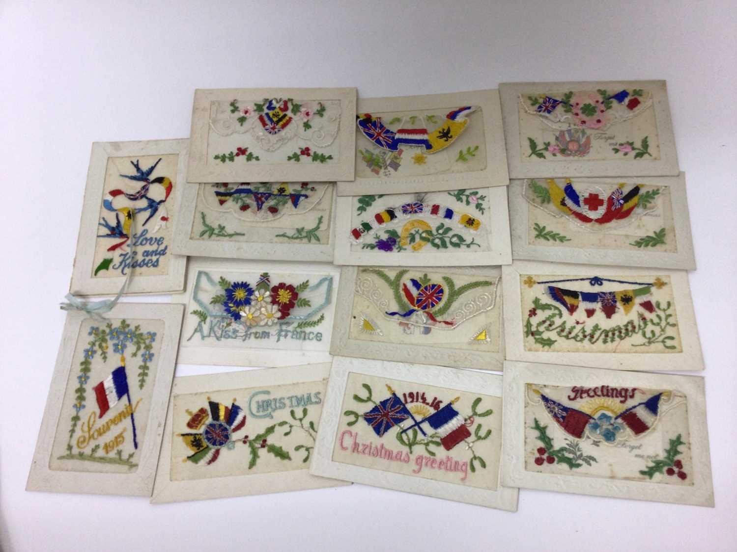 Lot 1428 - Postcards in album Military cards including WW1 Silk Embroidered Cards (13), real photographic Bridge Building Chatham, Xmas 1911 Multiview Brompton Barracks, WW1 French cards including Street Scen...