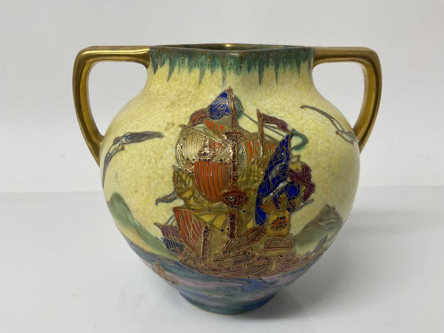 Lot 561 - Stylish Crown Devon Fieldings twin handled vase decorated with galleons at sea, 16cm high