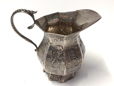 Lot 133 - Dutch silver cream jug with embossed figure and scroll decoration