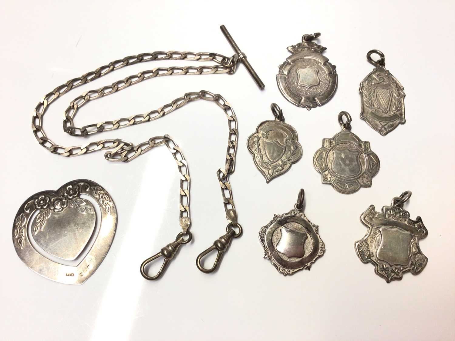 Lot 142 - Silver watch chain, group silver and plated fobs and silver bookmark