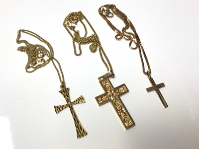 Lot 178 - Three 9ct gold cross pendants on 9ct gold chains