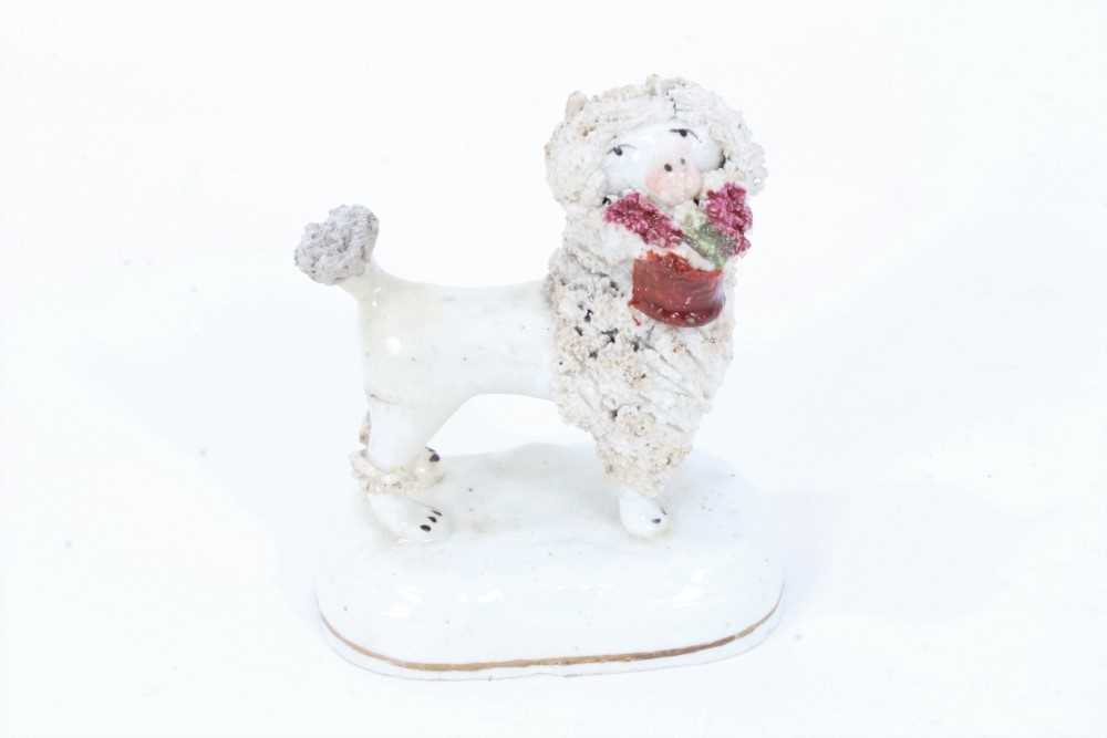 Lot 114 - Staffordshire porcelain model of a poodle carrying a basket, circa 1840