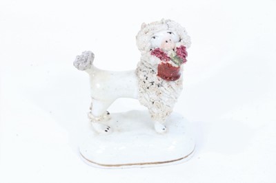 Lot 251 - Staffordshire porcelain model of a poodle carrying a basket, circa 1840