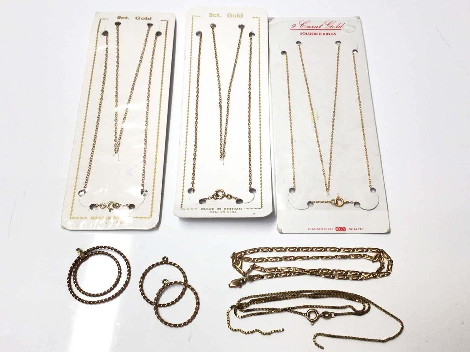 Lot 182 - Three 9ct gold chains in original packets, two other 9ct gold chains (broken)