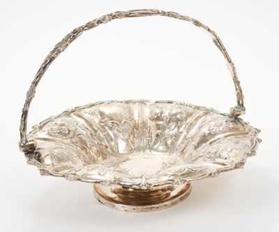 Lot 340 - George III silver swing handled fruit basket of circular form, with embossed floral decoration