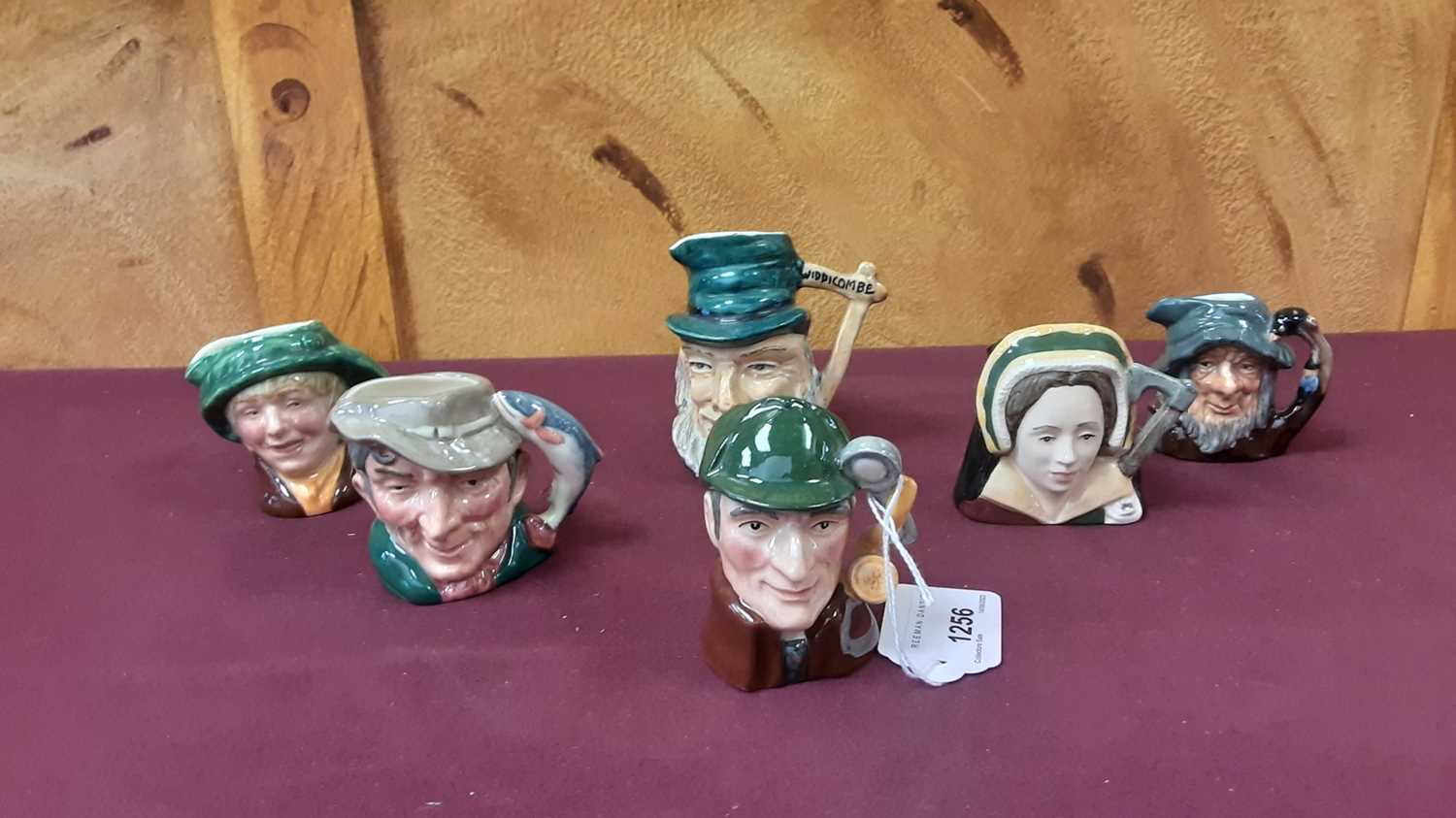 Lot 1256 - Collection of nineteen small Royal Doulton character jugs to include The Sleuth, The Guardsman and Catherine Howard, together with five other character jugs (24)