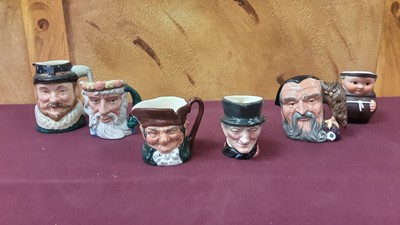 Lot 1256 - Collection of nineteen small Royal Doulton character jugs to include The Sleuth, The Guardsman and Catherine Howard, together with five other character jugs (24)
