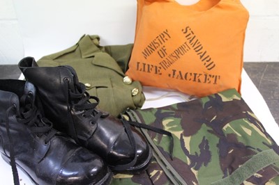 Lot 829 - Four boxes of military clothing and uniform to include hats, helmets and jacket and Police hats.