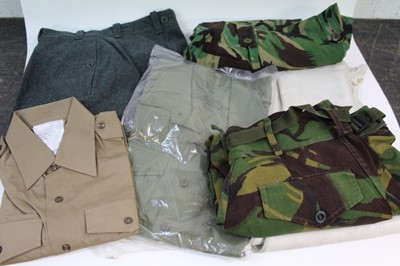 Lot 830 - Four boxes of military clothing and uniform to include jackets, Police helmets, hats etc