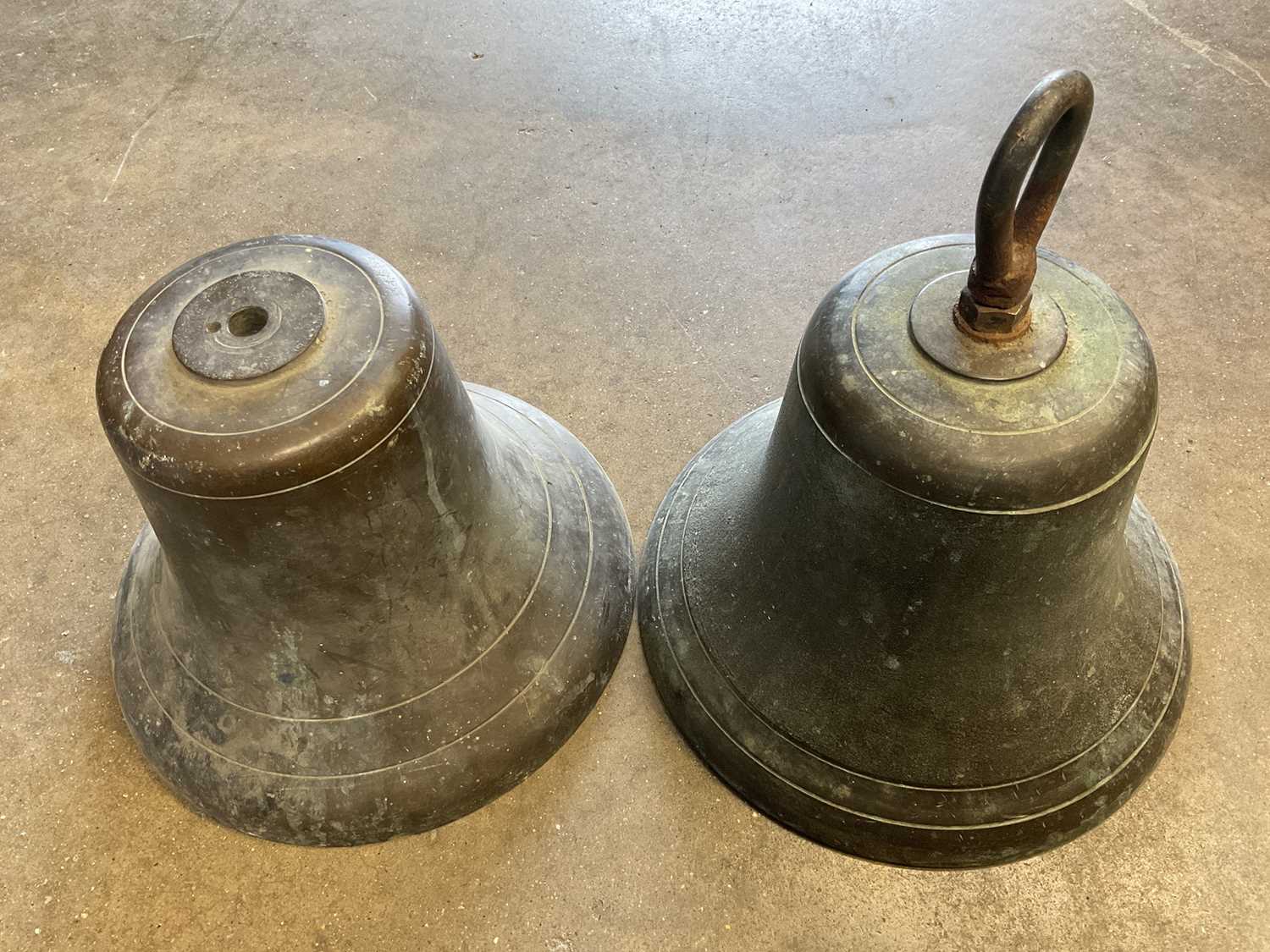 Lot 2617 - Near pair of antique bronze bells, one with suspension loop (total height 30cm)