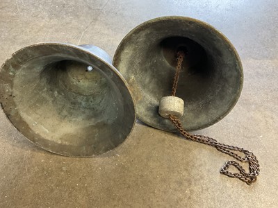 Lot 2617 - Near pair of antique bronze bells, one with suspension loop (total height 30cm)
