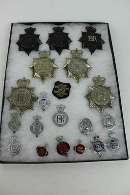 Lot 835 - Three cases of Elizabeth II Police helmet plates and other badges to include Warwickshire, Dorset and Lancashire (41 approximately badges)