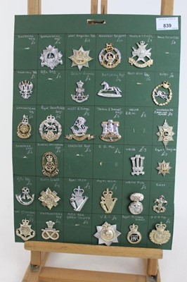 Lot 839 - Five boards mounted with British military cap badges, including two of staybrite badges mainly various regiments, some reproductions noted (approximately 146 badges)