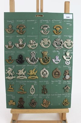 Lot 840 - Four boards mounted with British military cap badges, various regiments including Connaught Rangers, Somerset Light Infantry and Artists Rifles some reproductions noted (approximately 108 badges)