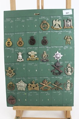 Lot 841 - Four boards mounted with British military cap badges, various regiments including Guards Machine Gun Corps, Royal Armoured Corps and Artists Rifles some reproductions noted (approximately 95 badges...