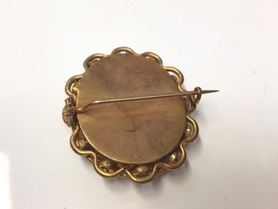Lot 311 - Victorian portrait brooch in gilt metal mount containing a daguerreotype portrait of a gentleman