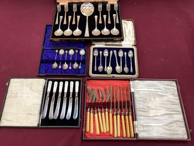 Lot 2642 - Collection of silver plated ware to include Tyg engraved 'U.C.S. Bicycle Race', pair of chamber sticks and cutlery sets together with a brass bell (1 box)