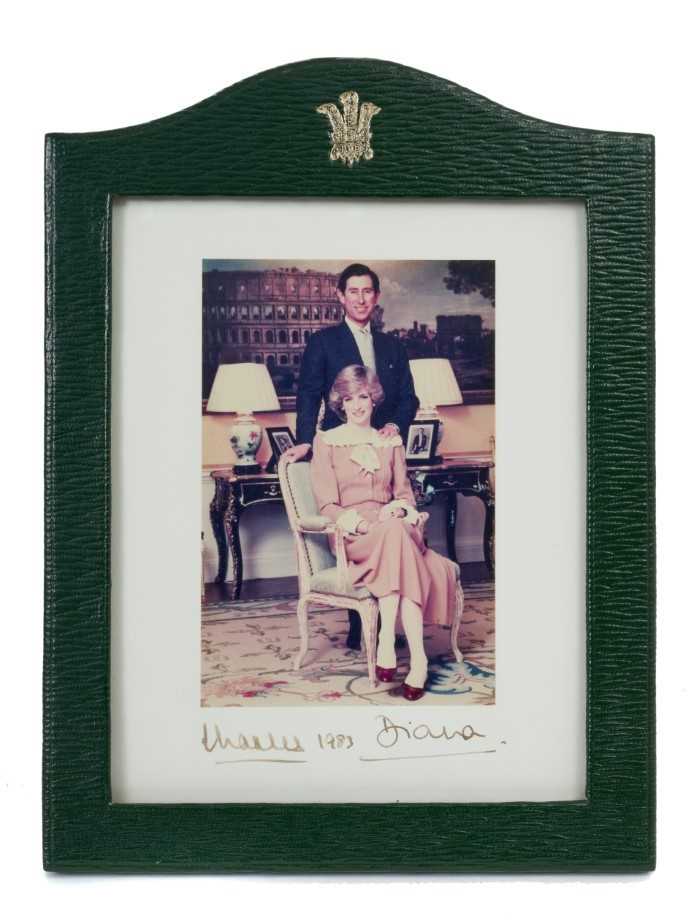 Lot 5 - T.R.H. The Prince and Princess of Wales, fine signed Royal Presentation colour portrait photogragh of the happy couple signed in ink 'Charles 1983 Diana ' in original green Morocco leather frame wi...