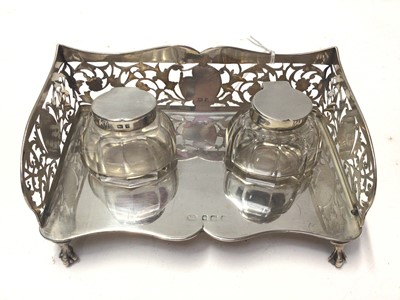 Lot 228 - Edwardian silver ink stand of rectangular form with pierced decoration, and two silver topped glass inkwells, (Birmingham 1906), 15.5cm in length, 4oz of weighable silver