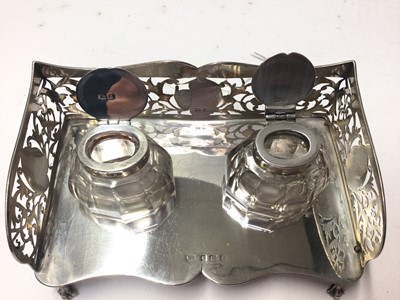 Lot 228 - Edwardian silver ink stand of rectangular form with pierced decoration, and two silver topped glass inkwells, (Birmingham 1906), 15.5cm in length, 4oz of weighable silver
