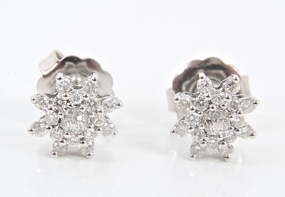 Lot 571 - Pair of diamond cluster earrings