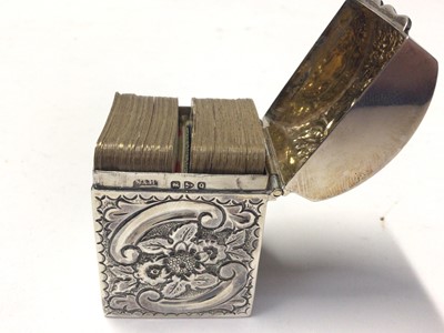 Lot 242 - Late Victorian silver box with embossed decoration, domed hinged lid and interior containing miniature playing cards, (Chester 1899), 5.5cm in height.