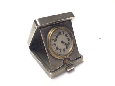 Lot 253 - George V Art Deco silver travelling time piece, mounted in a folding easel stand case with engine turned decoration, (Birmingham 1932), maker A. Cox, 5cm in length