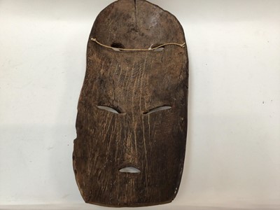 Lot 2662 - Large African wooden mask with four eyes, traces of polychrome, together with a smaller female African mask (2)