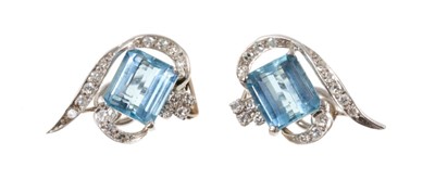 Lot 513 - Pair of aquamarine and diamond earrings, each with a rectangular step cut aquamarine measuring approximately 9.4mm x 8.5mm, in diamond-set scrolls with white gold clip fittings