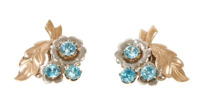 Lot 514 - Pair of 1940s/1950s blue zircon white and yellow gold floral spray earrings with clip fittings