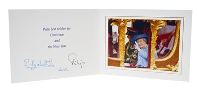 Lot 14 - H.M.Queen Elizabeth II and H.R.H. The Duke of Edinburgh, signed 2002 Christmas card with twin gilt Royal ciphers to cover, colour photograph of the smiling Royal couple in the State coach to the in...