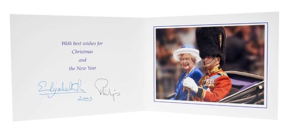 Lot 15 - H.M. Queen Elizabeth II and H.R.H. The Duke of Edinburgh, signed 2003 Christmas card with twin gilt Royal ciphers to cover, colour photograph of the Royal couple riding in an open carriage to the i...