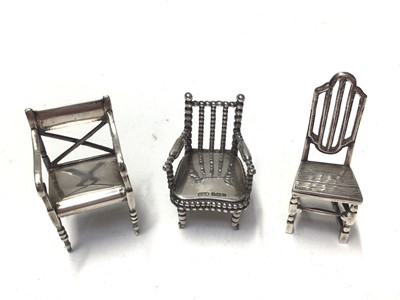 Lot 288 - George V silver miniature chair engraved Raleigh 1552 - 1618, (Birmingham 1910), maker Levi and Salaman, together with another engraved Napoleon 1769 - 1821, (Birmingham 1917) and a third miniature...