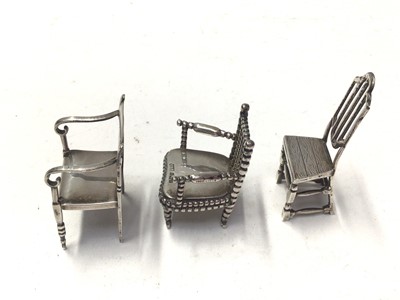 Lot 288 - George V silver miniature chair engraved Raleigh 1552 - 1618, (Birmingham 1910), maker Levi and Salaman, together with another engraved Napoleon 1769 - 1821, (Birmingham 1917) and a third miniature...
